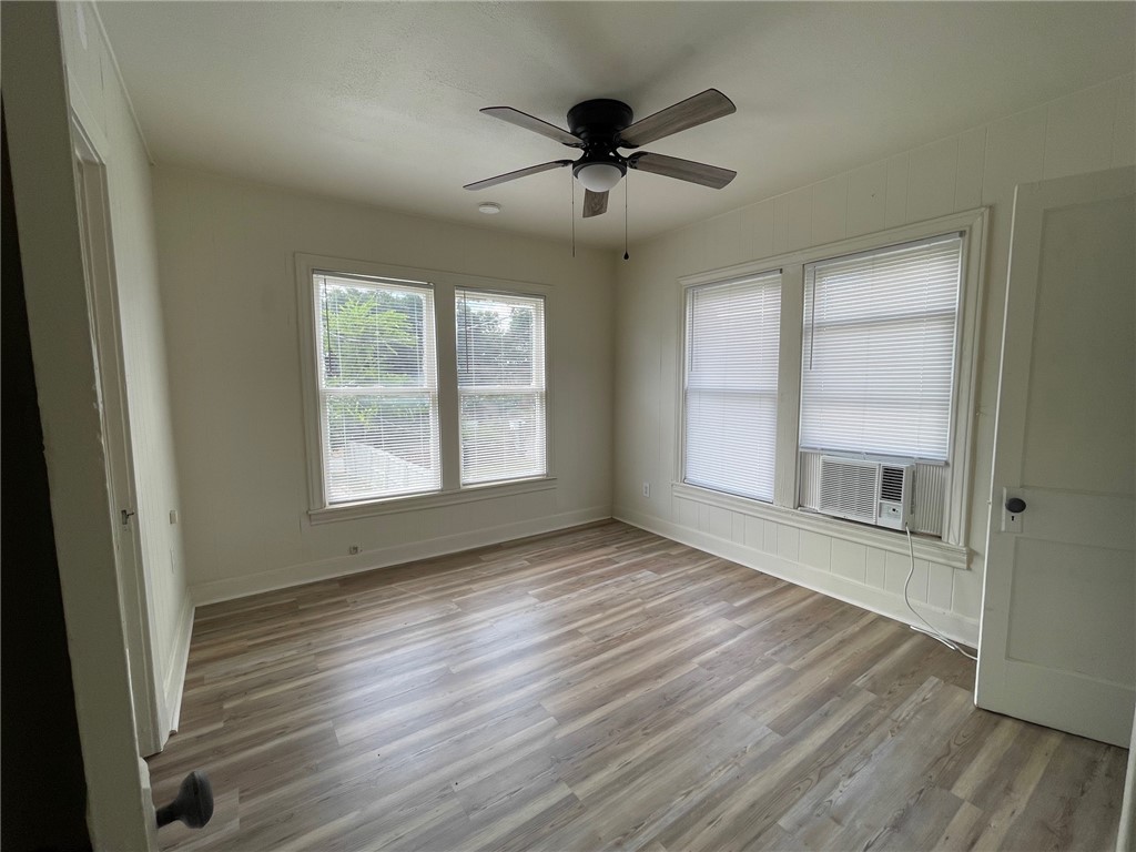 408 Hill Street Bryan, TX 77803 - Photo 11 of 13 a view of an empty room with wooden floor and a window