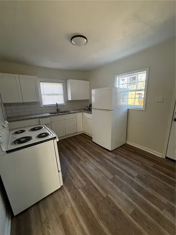 a kitchen with a stove a sink and a refrigerator
