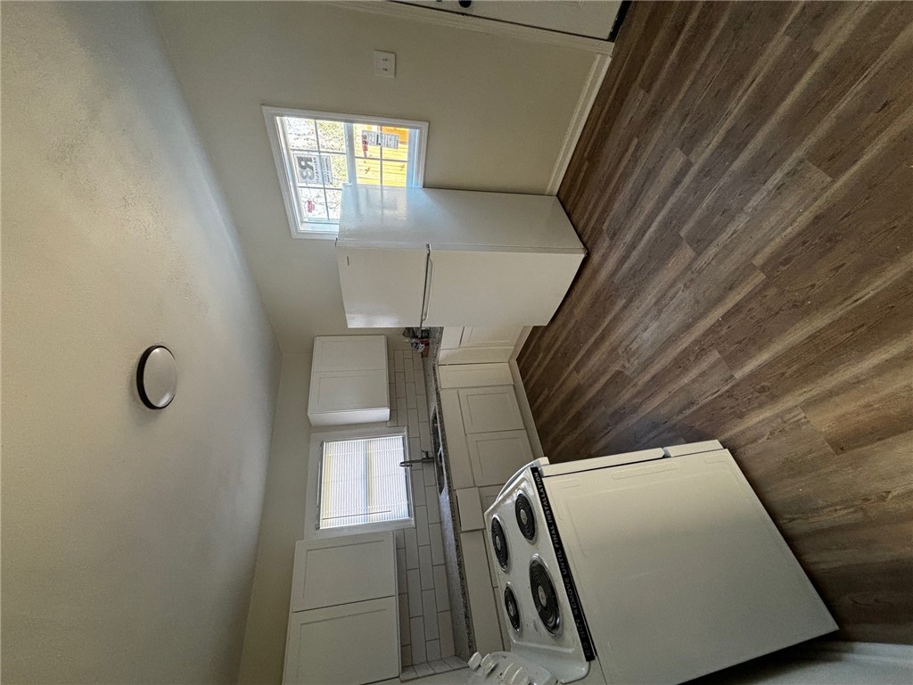 408 Hill Street Bryan, TX 77803 - Photo 5 of 13 a kitchen with a stove a sink and a refrigerator