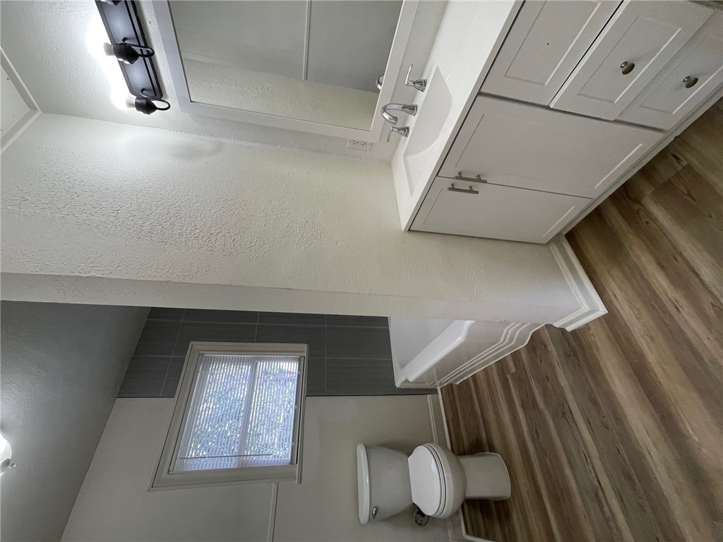 408 Hill Street Bryan, TX 77803 - Photo 9 of 13 a bathroom with a sink toilet and a mirror