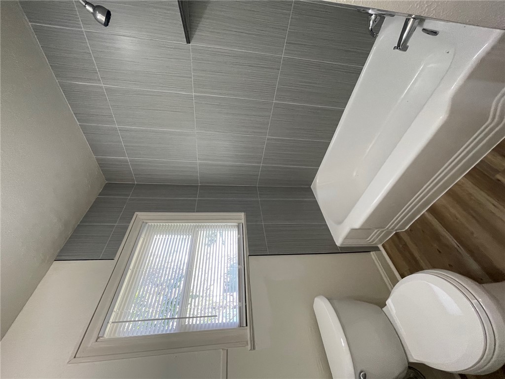 408 Hill Street Bryan, TX 77803 - Photo 10 of 13 a bathroom with a toilet and a shower