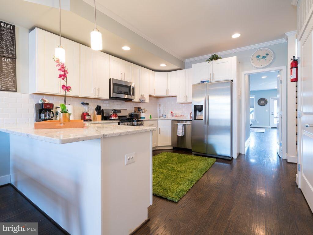 732 Girard Street Northwest, Unit 1 Washington, DC 20001 - Photo 2 of 10 a kitchen with stainless steel appliances granite countertop a refrigerator a sink and a stove