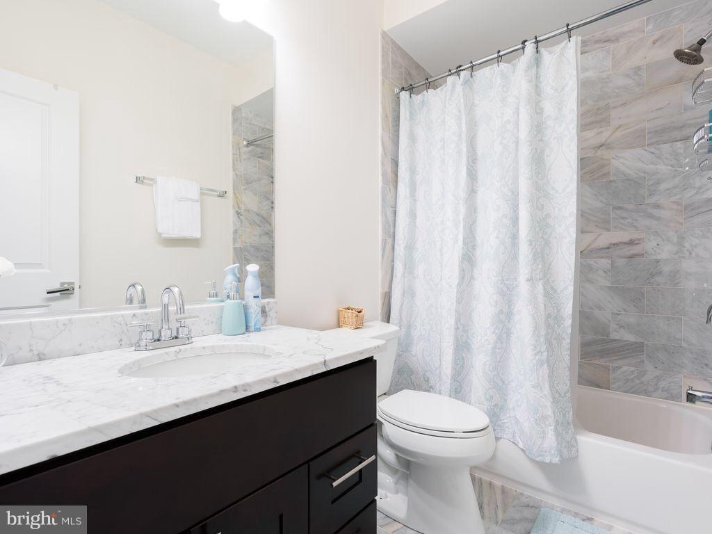 732 Girard Street Northwest, Unit 1 Washington, DC 20001 - Photo 4 of 10 a bathroom with a sink a toilet and a bathtub