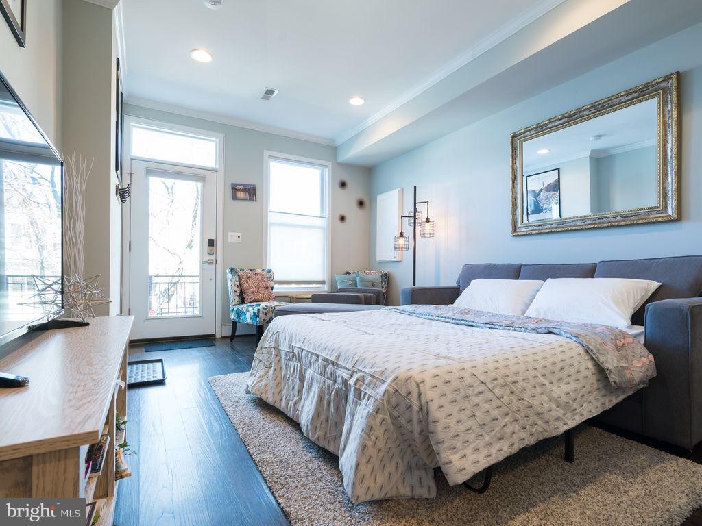 732 Girard Street Northwest, Unit 1 Washington, DC 20001 - Photo 7 of 10 a bedroom with a bed and glass windows