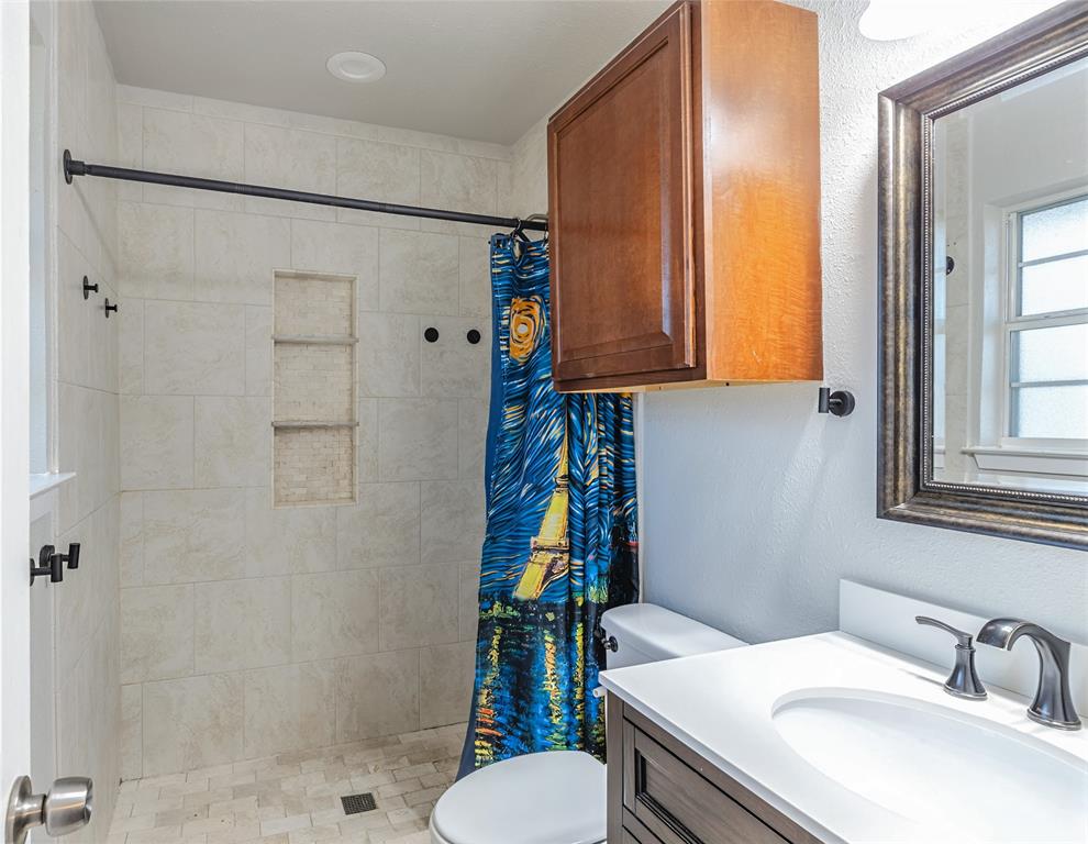 6501 Patsy Lane Watauga, TX 76148 - Photo 16 of 24 a bathroom with a sink toilet and shower