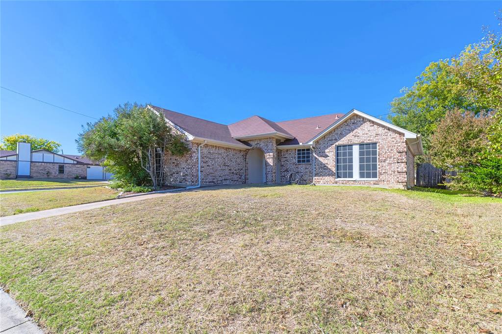 6501 Patsy Lane Watauga, TX 76148 - Photo 2 of 24 a view of a house with a yard and a large tree