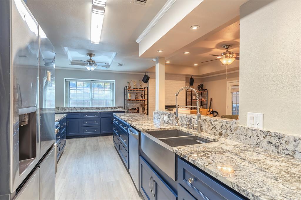 6501 Patsy Lane Watauga, TX 76148 - Photo 10 of 24 a kitchen with kitchen island granite countertop a sink stove and refrigerator