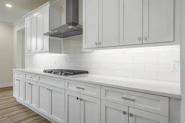 a room with a walk in closet and wooden floor