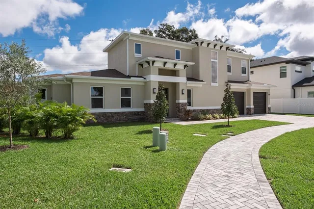 a front view of a house with a yard and garage