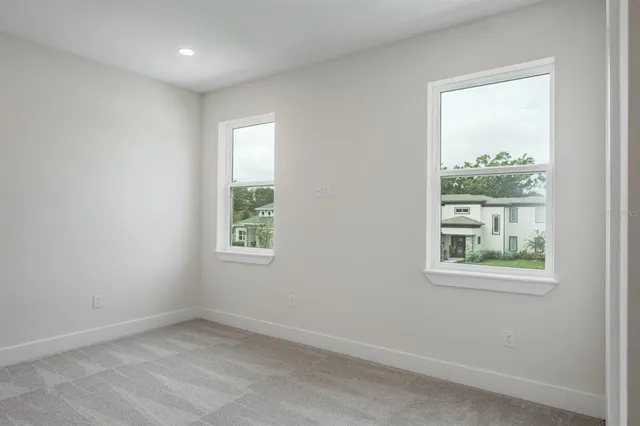 an empty room with windows and closet