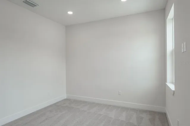 a view of a house with a yard and pathway