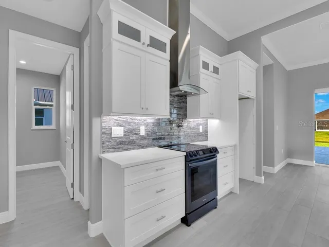 a kitchen with stainless steel appliances granite countertop a stove and a refrigerator