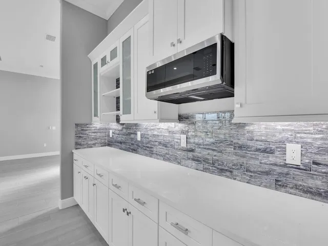a kitchen with stainless steel appliances granite countertop a sink and a microwave