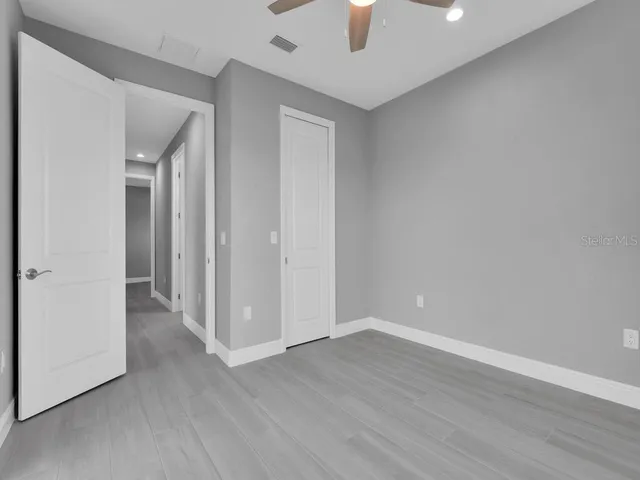 a view of an empty room with wooden floor
