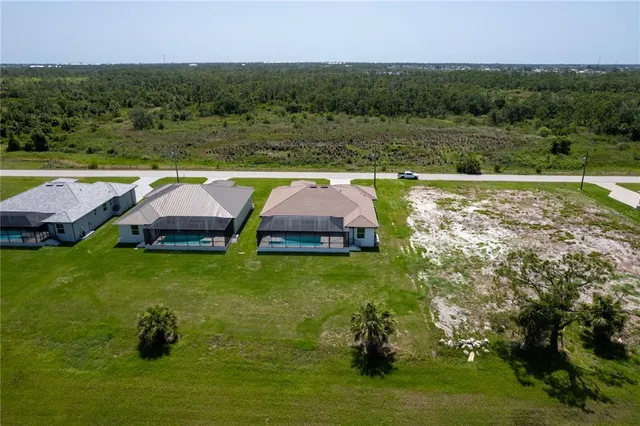 an aerial view of a house having yard and green space