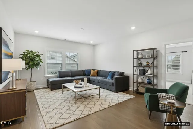 a view of a hallway with wooden floor and windows