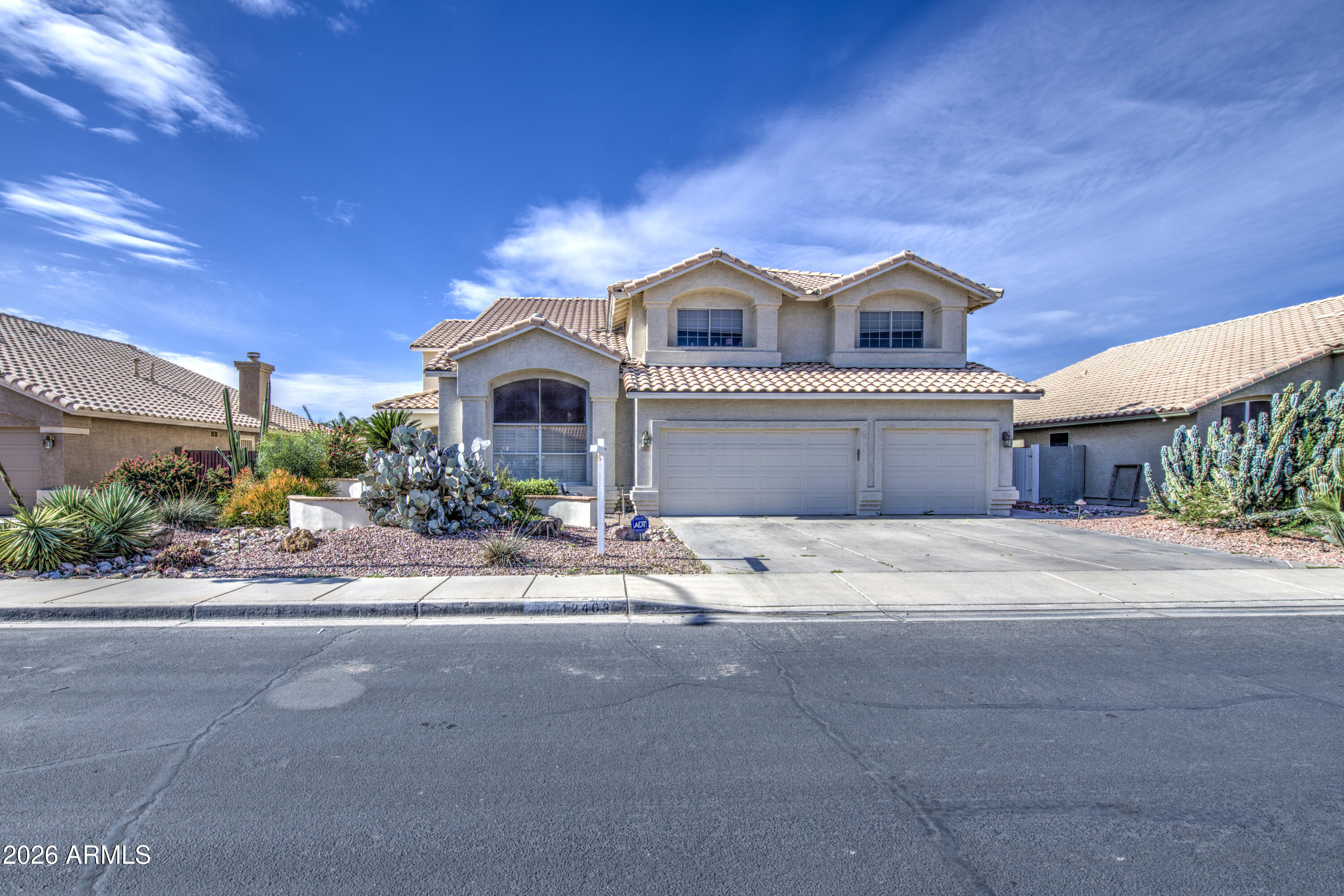 12403 West Monte Vista Road Avondale, AZ 85392 - Photo 4 of 63 a front view of a house with a garage