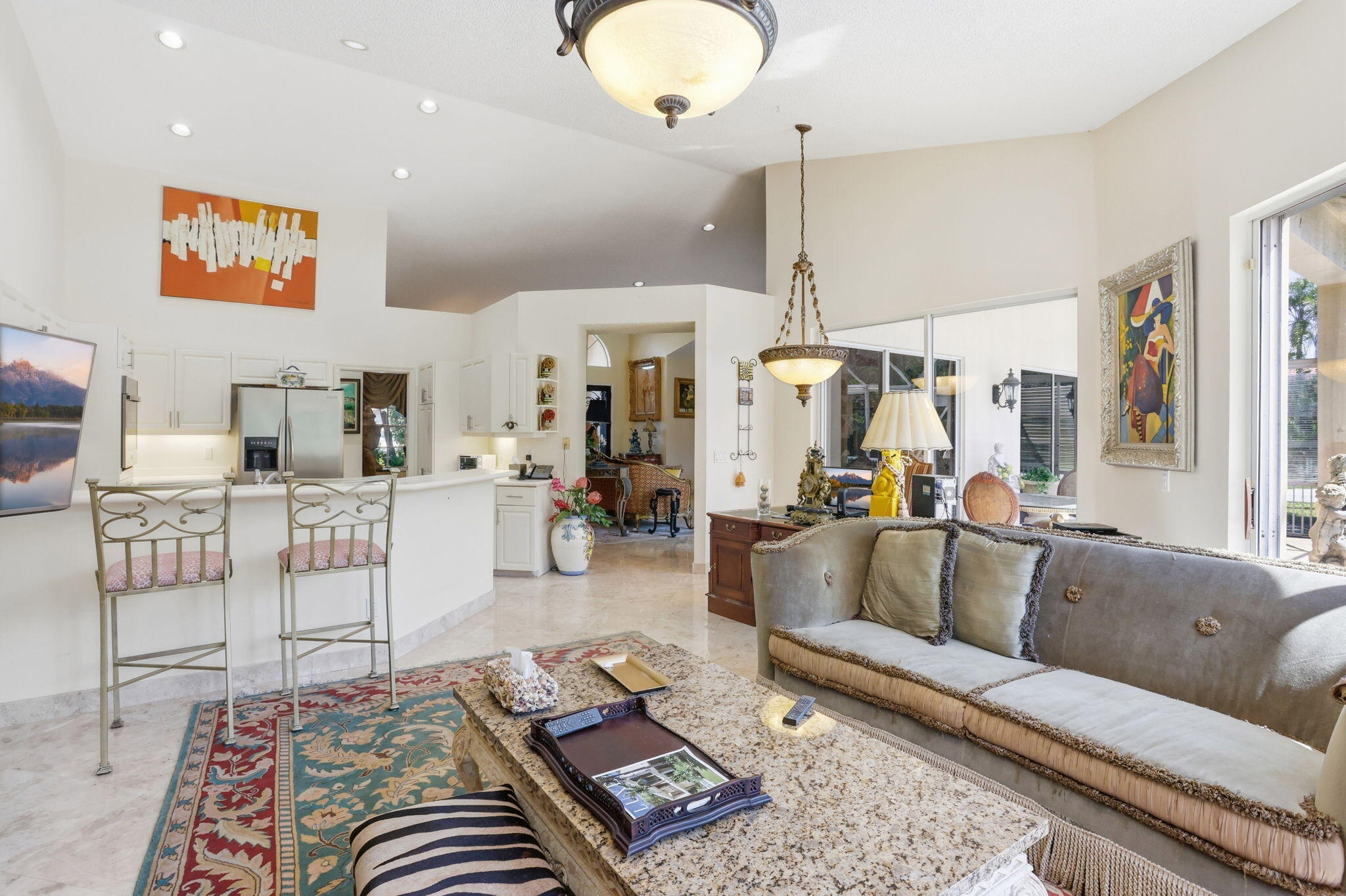 7821 Dorchester Road Boynton Beach, FL 33472 - Photo 13 of 49 a living room with furniture and a chandelier