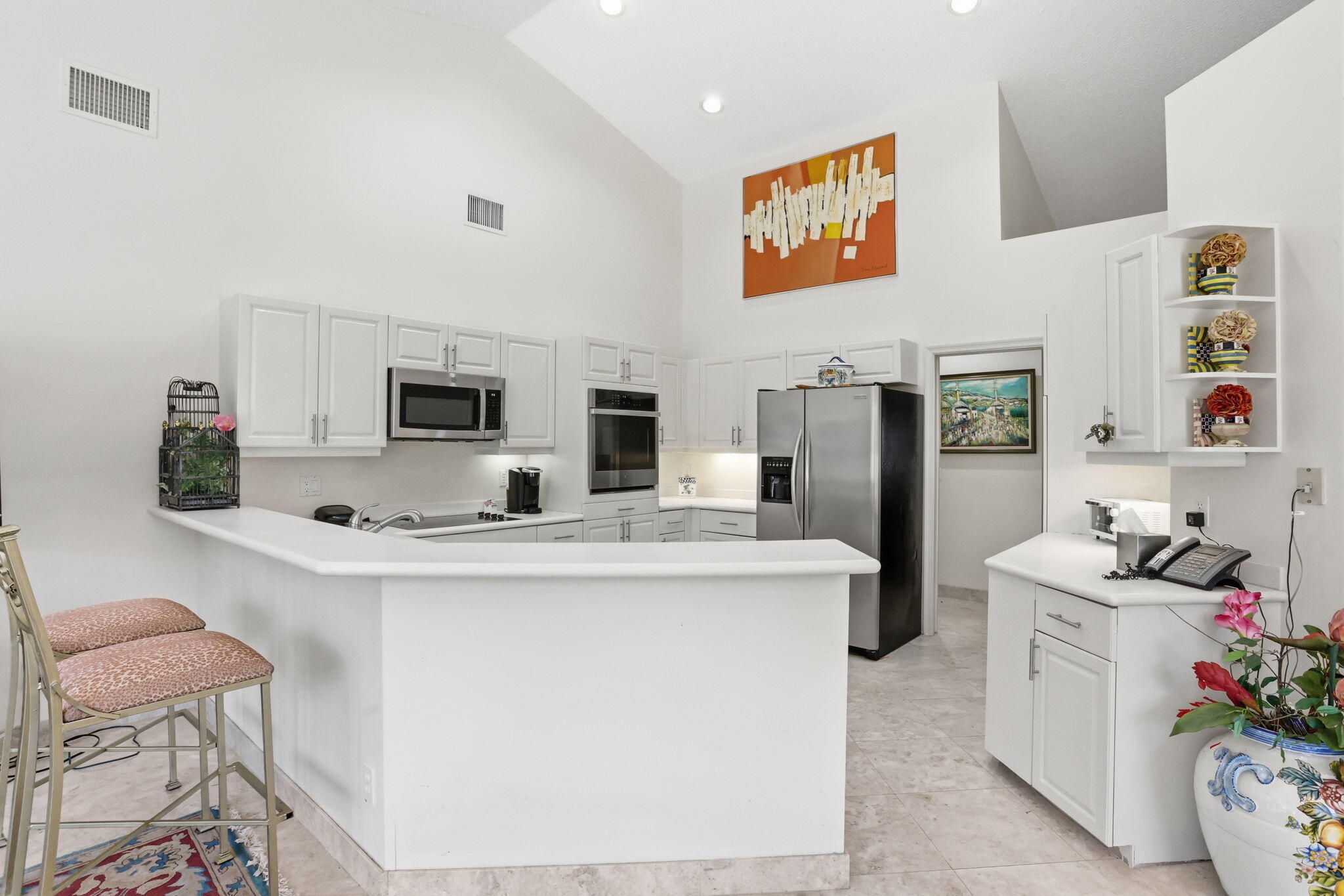 7821 Dorchester Road Boynton Beach, FL 33472 - Photo 14 of 49 a kitchen with stainless steel appliances a sink and a refrigerator