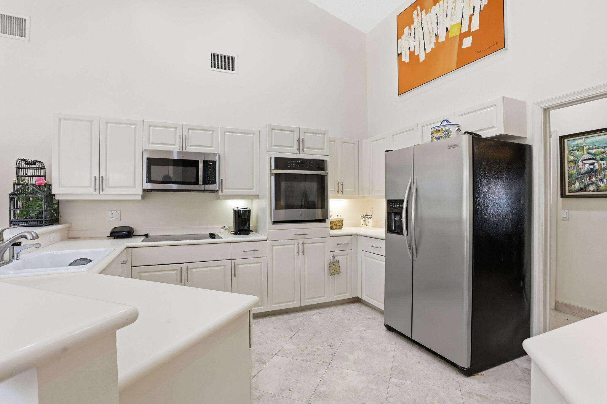 7821 Dorchester Road Boynton Beach, FL 33472 - Photo 15 of 49 a kitchen with a refrigerator sink and microwave