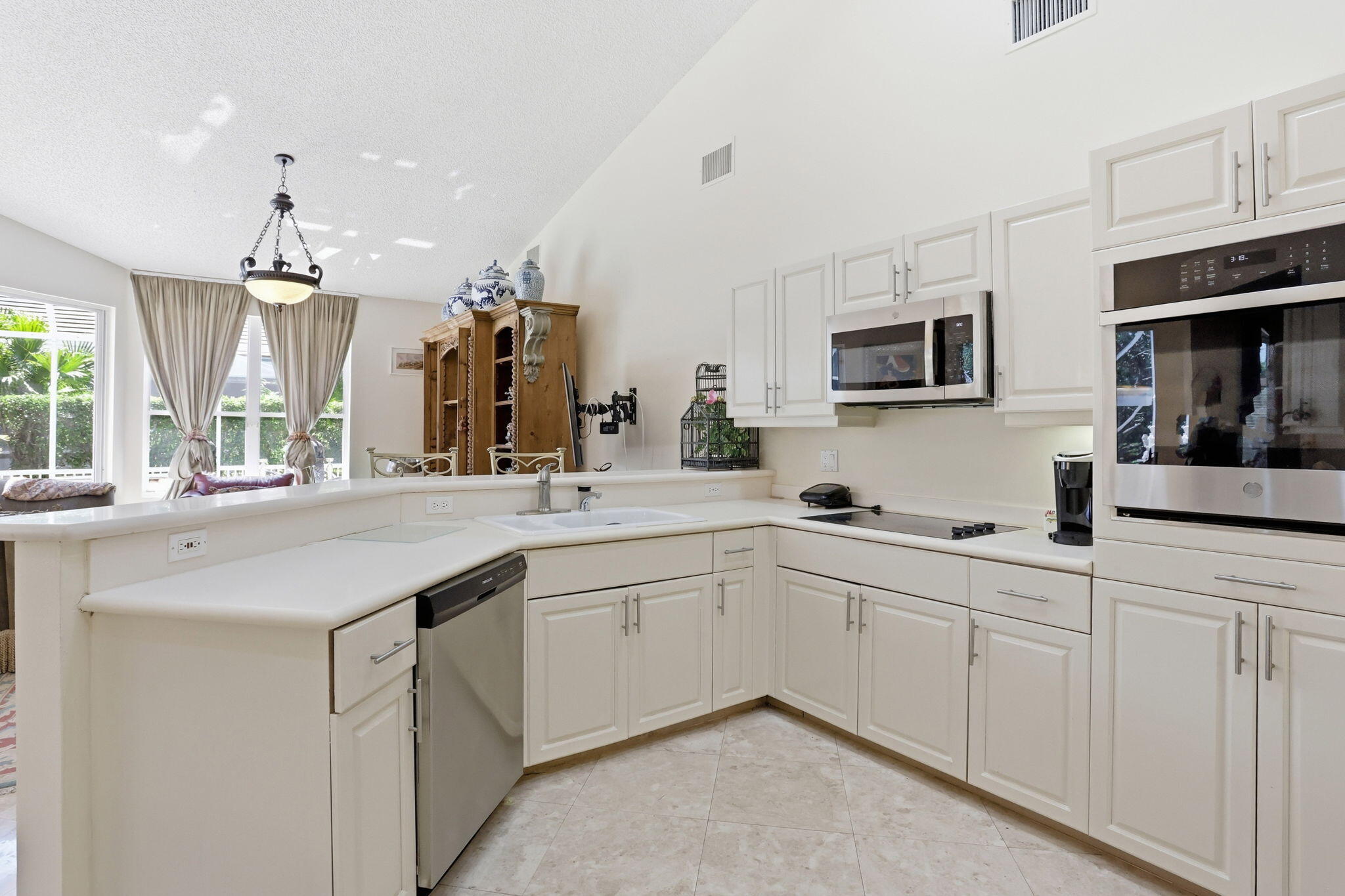 7821 Dorchester Road Boynton Beach, FL 33472 - Photo 16 of 49 a kitchen with cabinets a sink and appliances