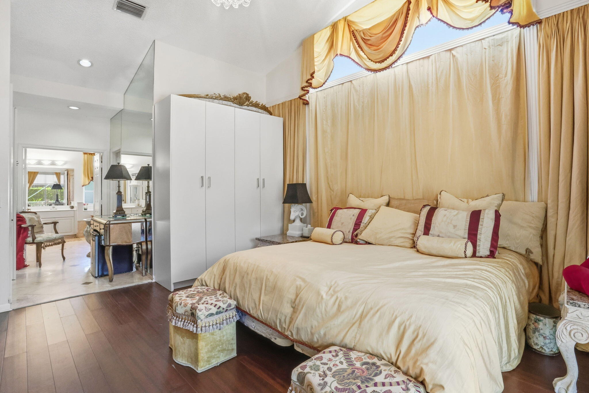 7821 Dorchester Road Boynton Beach, FL 33472 - Photo 18 of 49 a bedroom with a bed and a chandelier