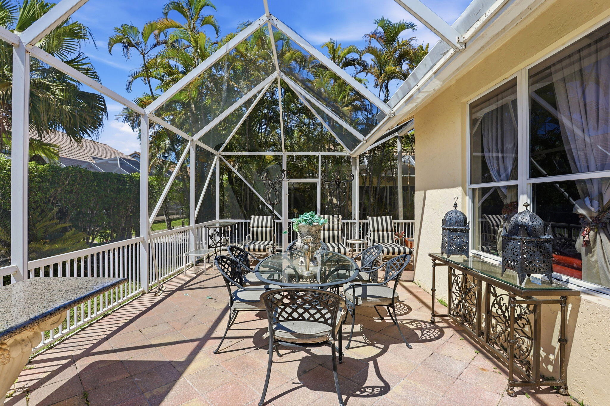 7821 Dorchester Road Boynton Beach, FL 33472 - Photo 22 of 49 a view of a chair and tables in the balcony