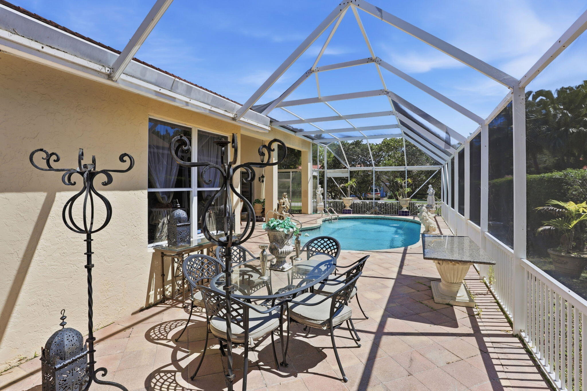 7821 Dorchester Road Boynton Beach, FL 33472 - Photo 23 of 49 a patio with table and chairs