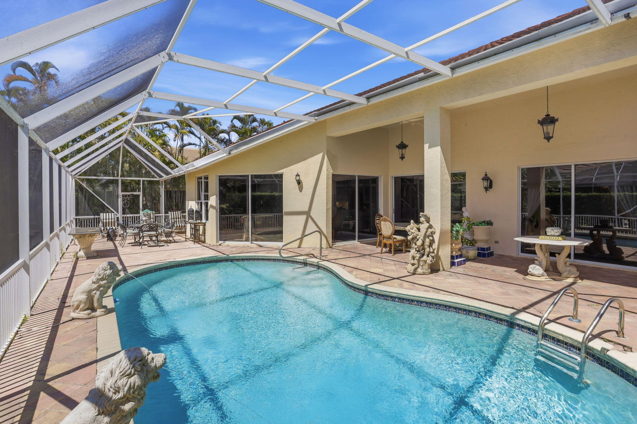 7821 Dorchester Road Boynton Beach, FL 33472 - Photo 24 of 49 a view of a patio with table and chairs and potted plants