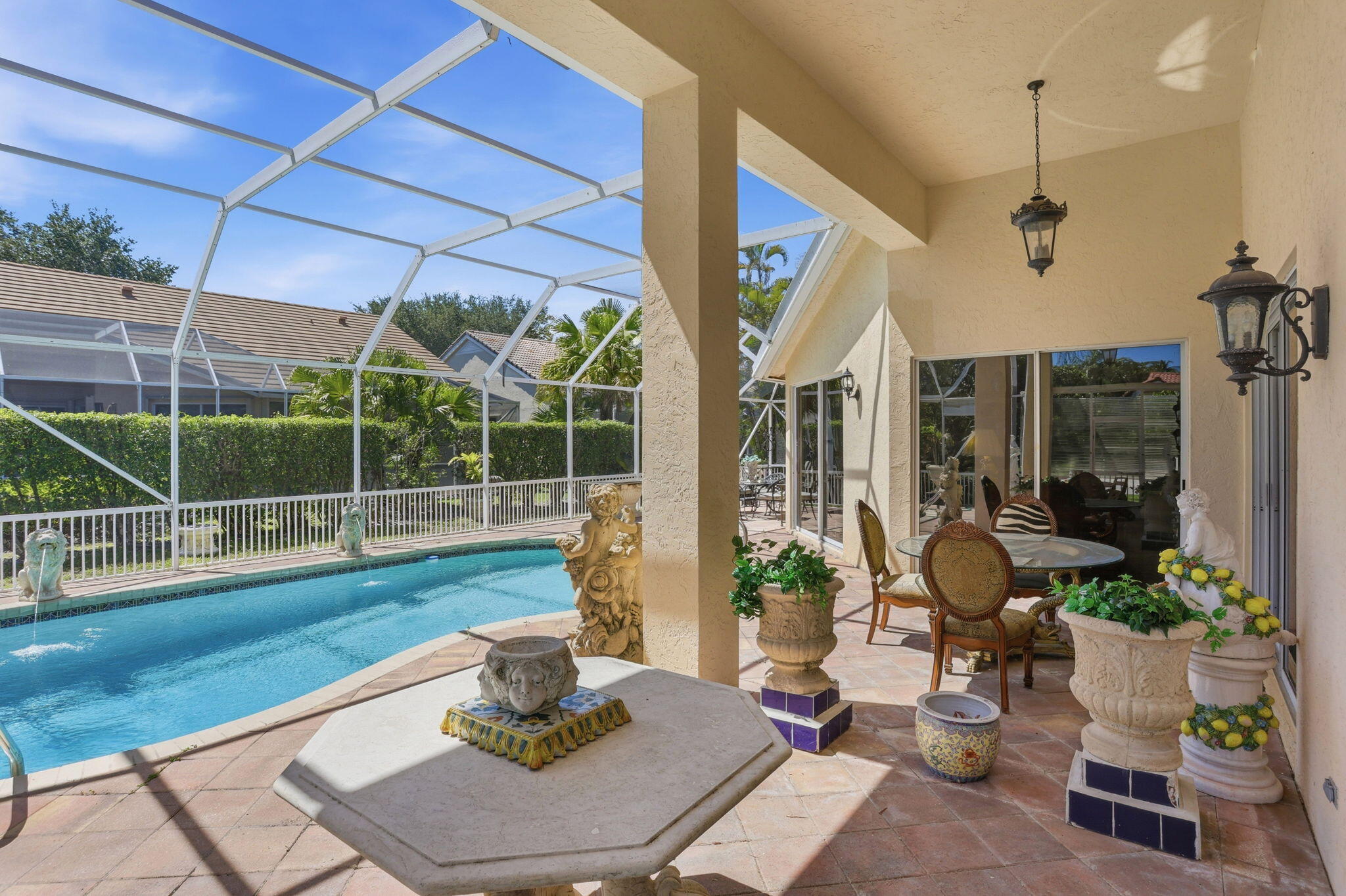 7821 Dorchester Road Boynton Beach, FL 33472 - Photo 26 of 49 a view of a patio with couches chairs and potted plants