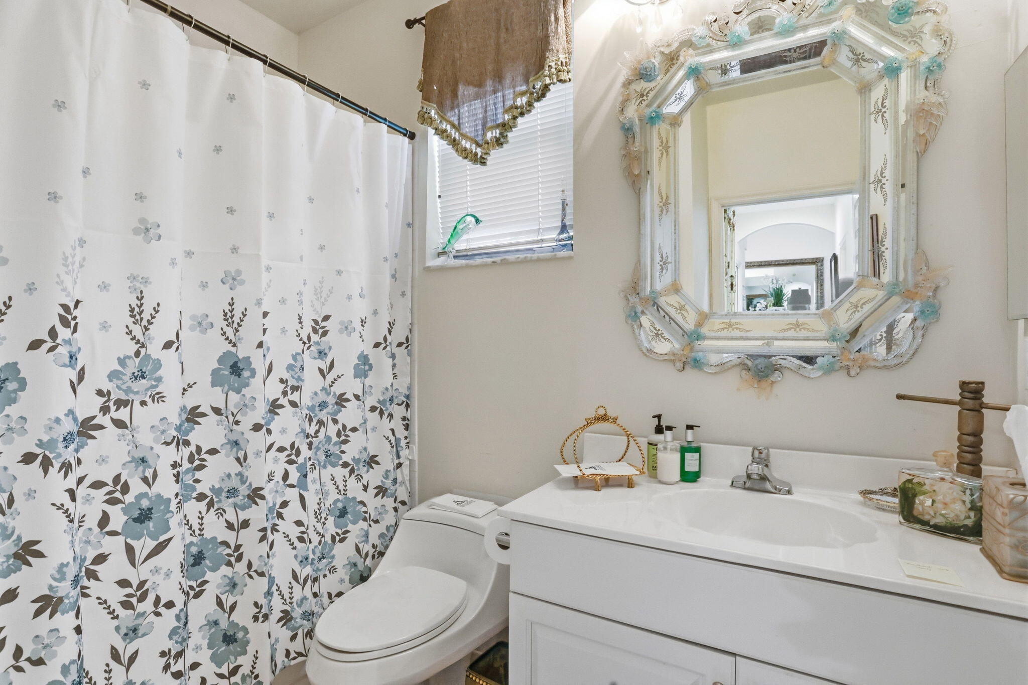 7821 Dorchester Road Boynton Beach, FL 33472 - Photo 29 of 49 a bathroom with a sink a toilet and a mirror