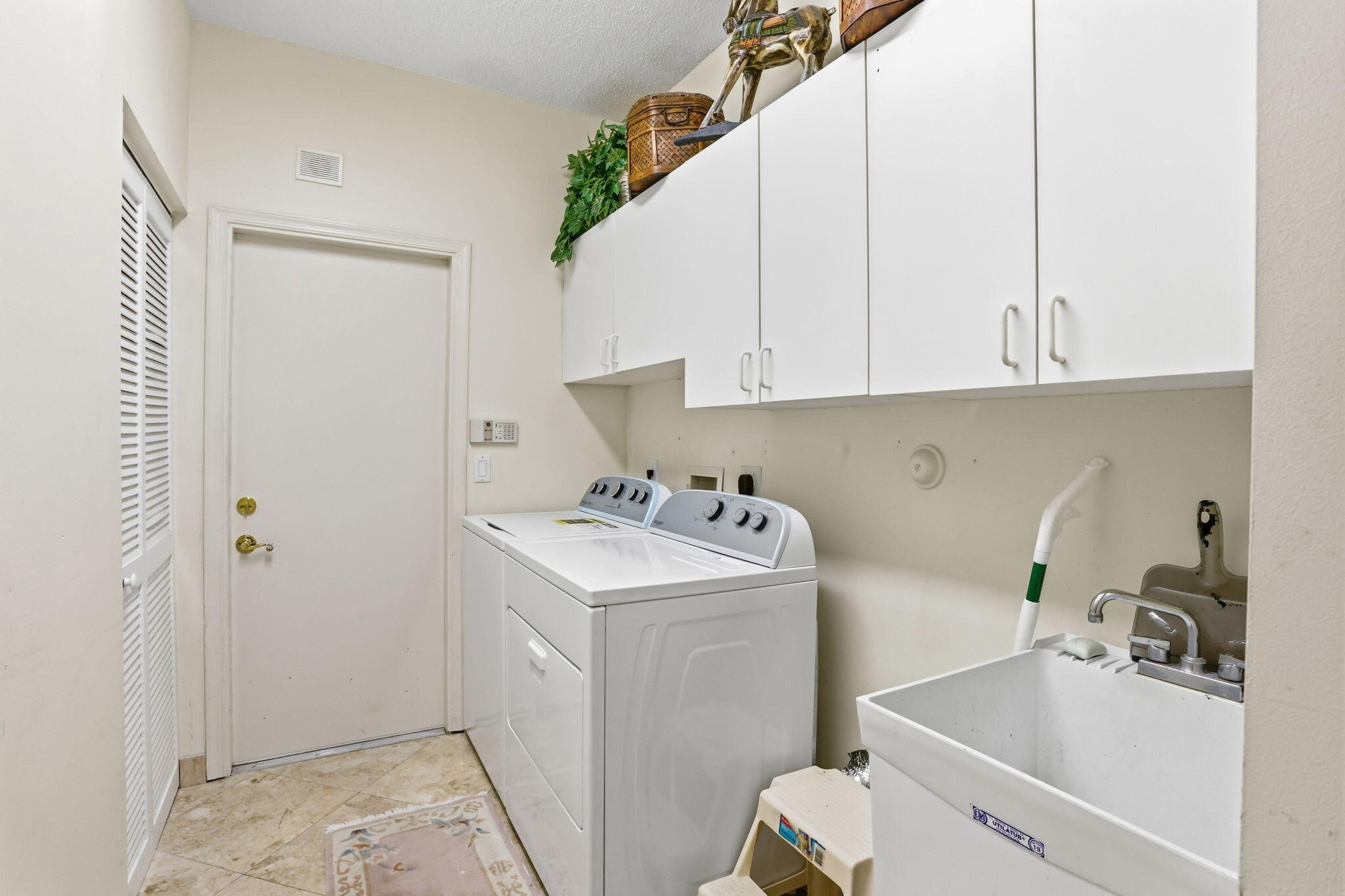 7821 Dorchester Road Boynton Beach, FL 33472 - Photo 32 of 49 a view of bathroom with a sink and cabinets
