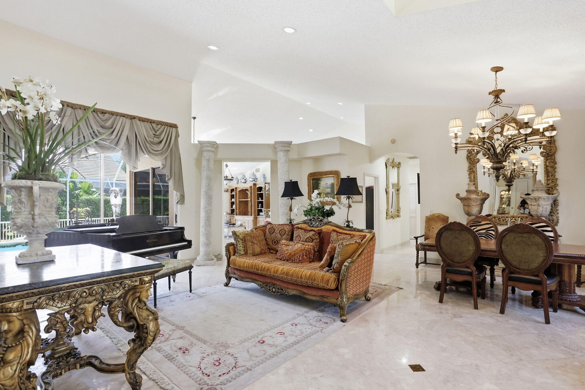 7821 Dorchester Road Boynton Beach, FL 33472 - Photo 6 of 49 a living room with furniture and a chandelier
