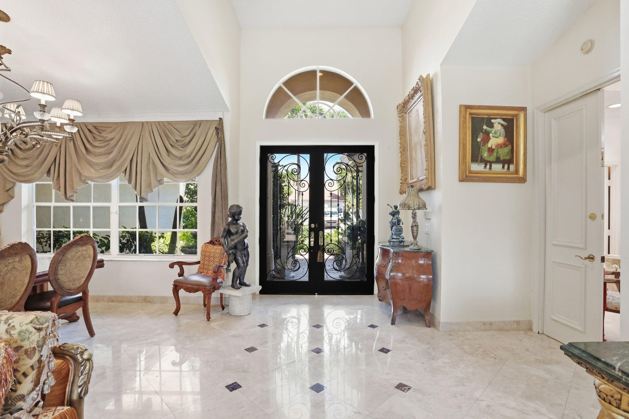 7821 Dorchester Road Boynton Beach, FL 33472 - Photo 7 of 49 a living room with furniture a window and a chandelier