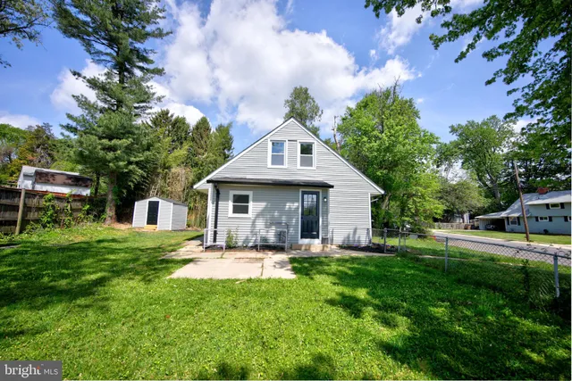 a front view of a house with yard and green space