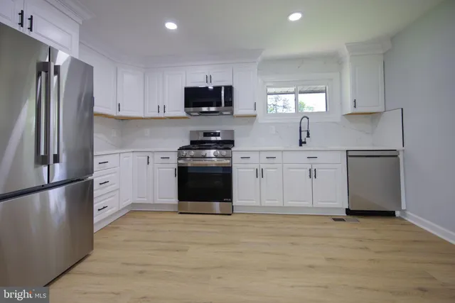 a bathroom with a toilet a sink and a mirror