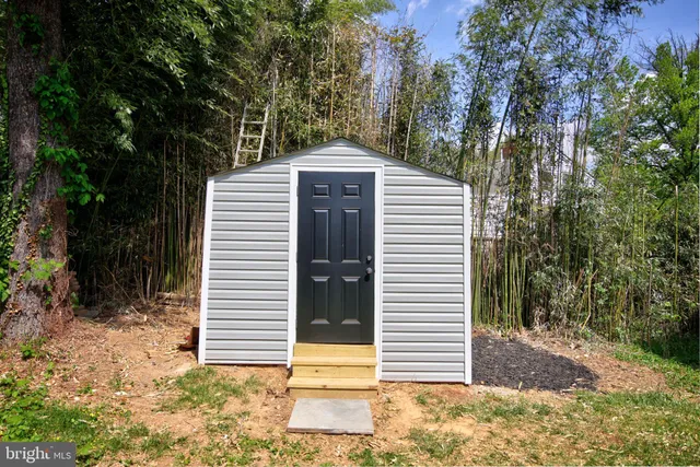 a view of a house with a big yard and a large tree