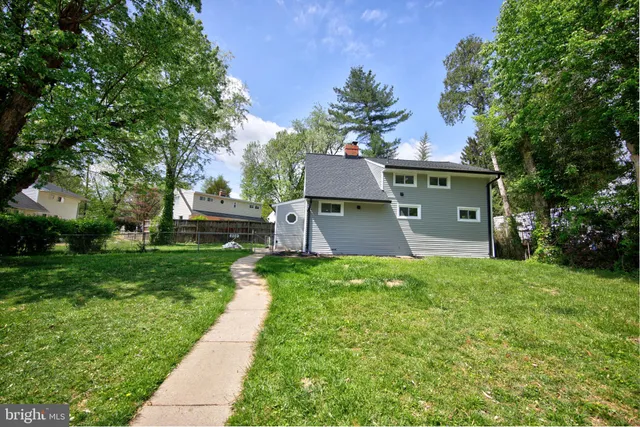 a view of yard with swimming pool and green space