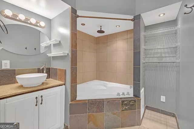 a bedroom with furniture and a large window