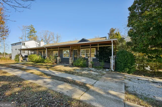 a front view of a house with a yard outdoor seating and garage