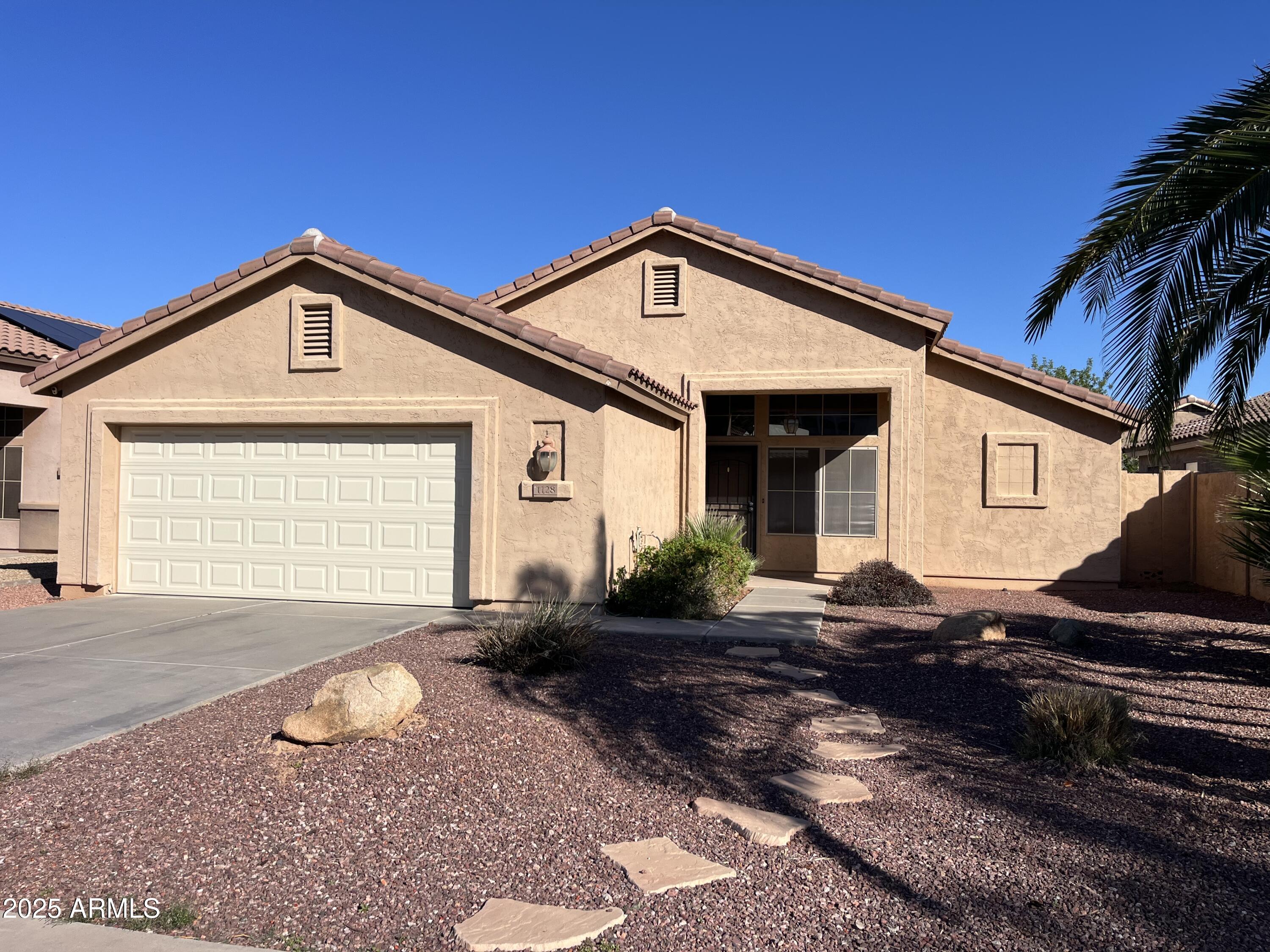 1128 East Sheffield Avenue Gilbert, AZ 85296 - Photo 1 of 24 a front view of a house with a yard