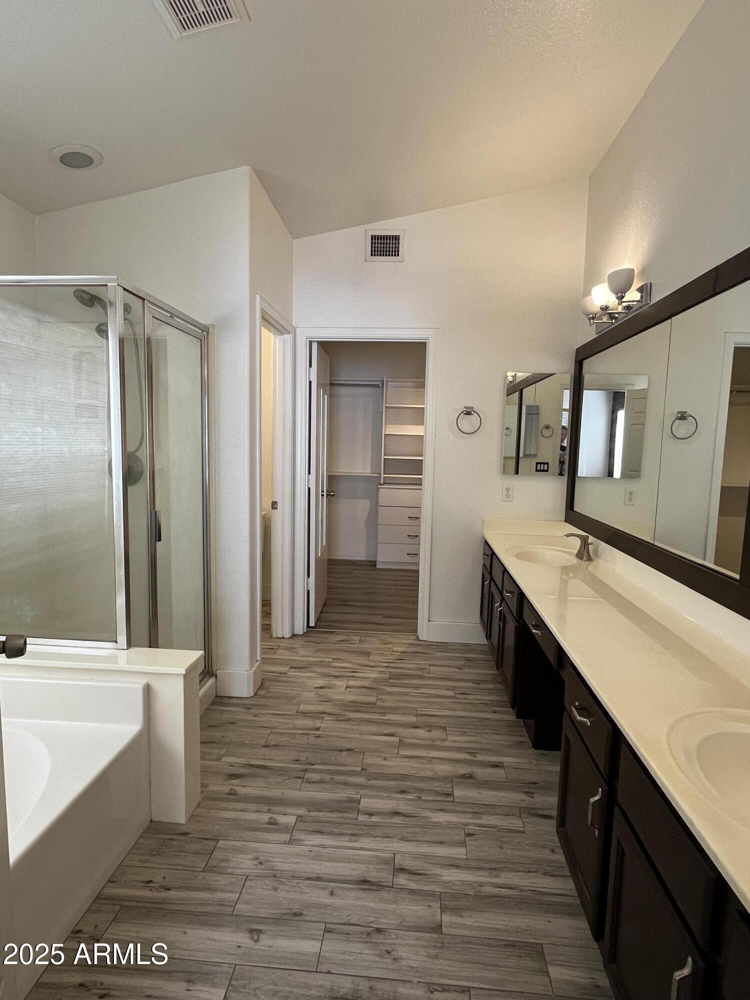 1128 East Sheffield Avenue Gilbert, AZ 85296 - Photo 15 of 24 a large bathroom with a double vanity sink a large mirror and a bathtub