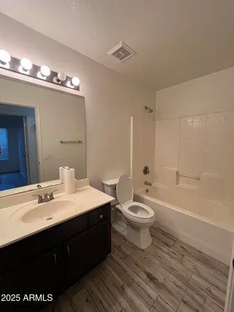 a bathroom with a double vanity sink toilet and shower