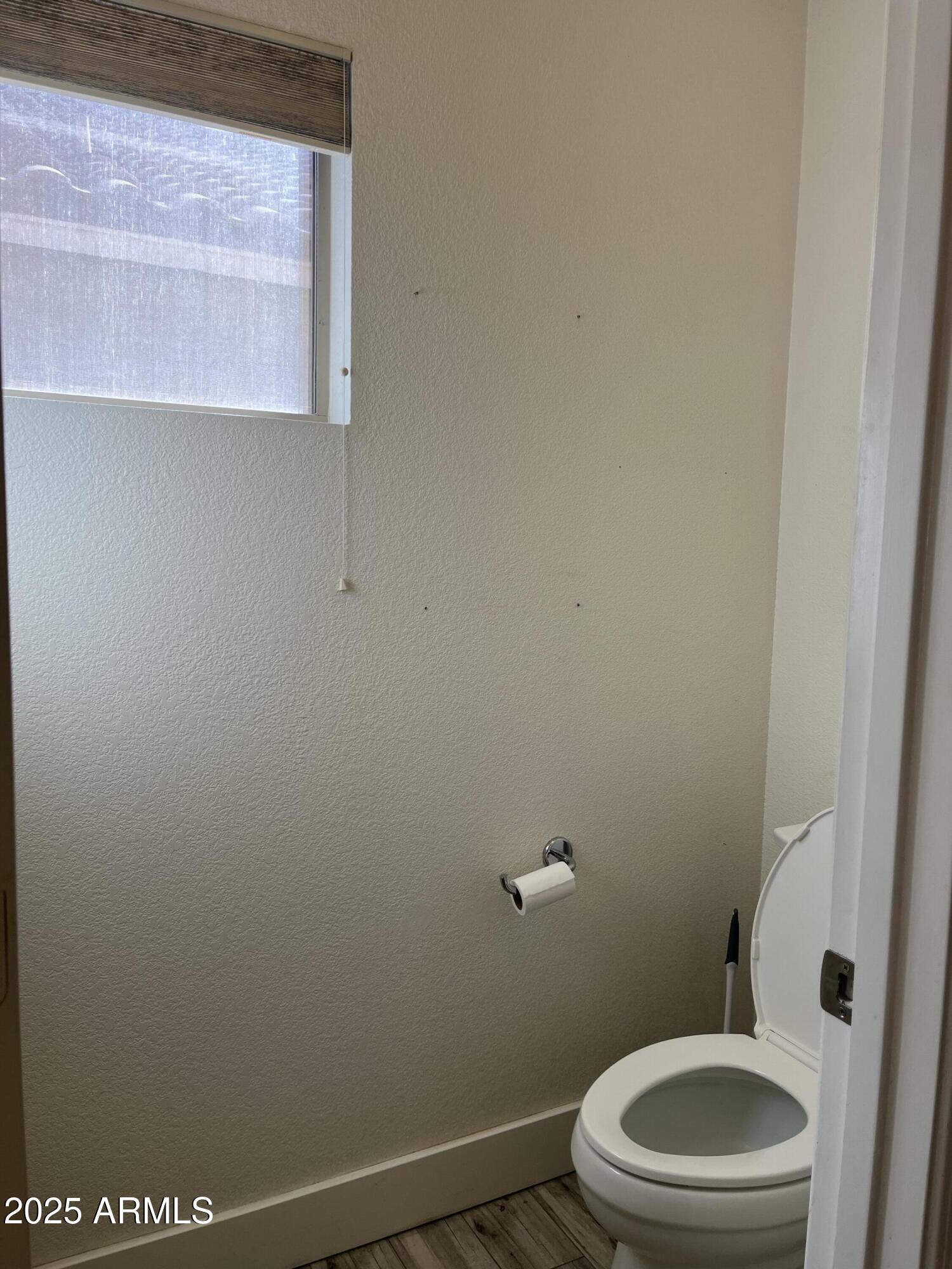 1128 East Sheffield Avenue Gilbert, AZ 85296 - Photo 20 of 24 a white toilet sitting next to a white sink and vanity