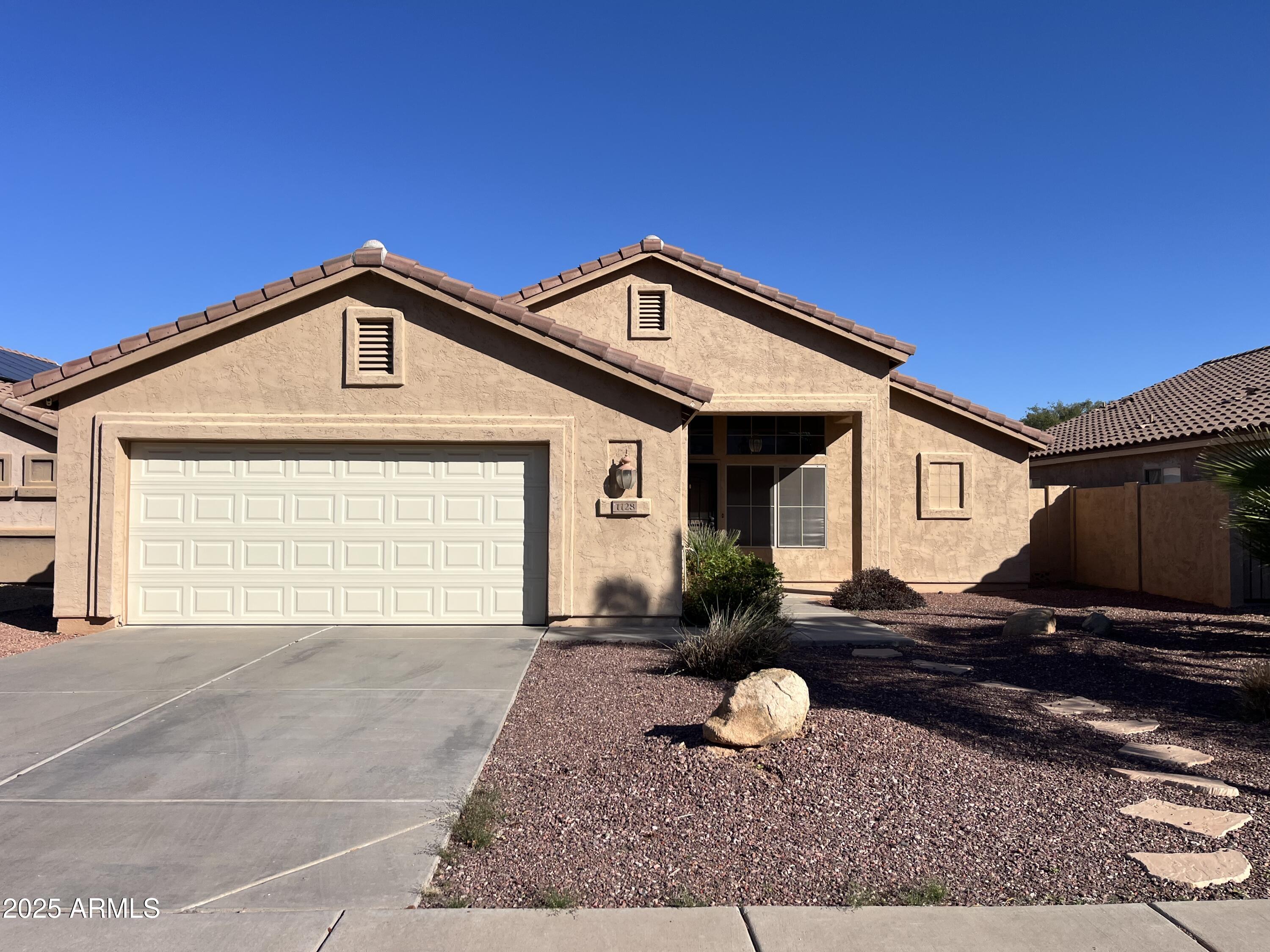 1128 East Sheffield Avenue Gilbert, AZ 85296 - Photo 2 of 24 a front view of a house with garden