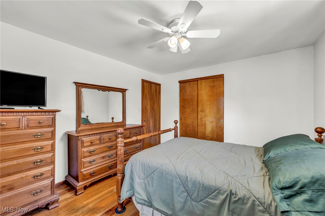 13732 Carpenter Road Garfield Heights, OH 44125 - Photo 23 of 46 Bedroom featuring wood finished floors, a ceiling fan, and a closet