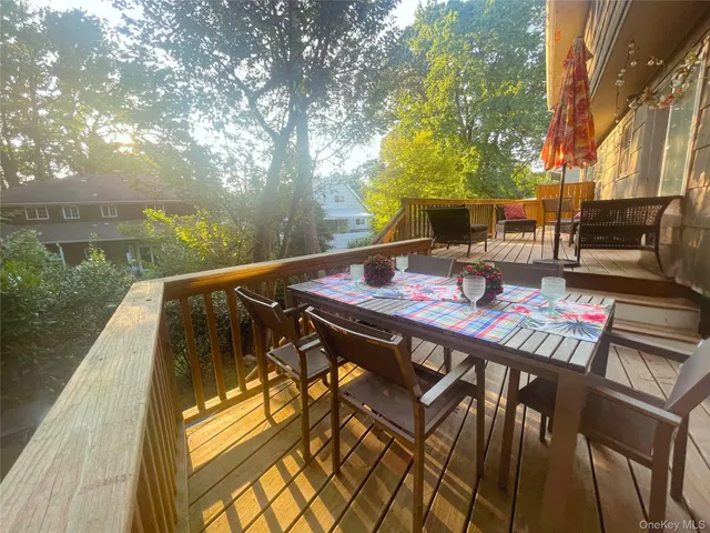 a view of two chairs and table in the patio