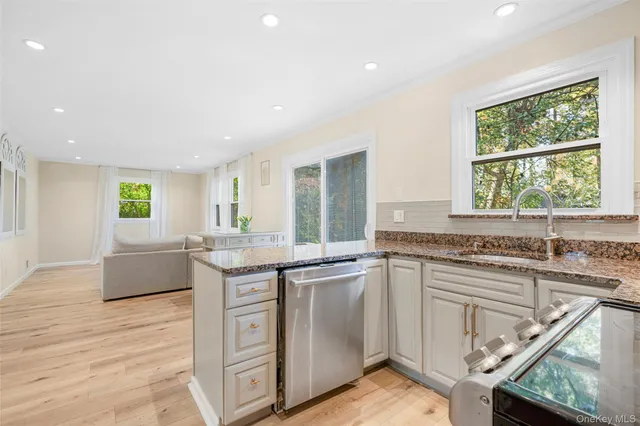 a kitchen with stainless steel appliances granite countertop a stove and a sink