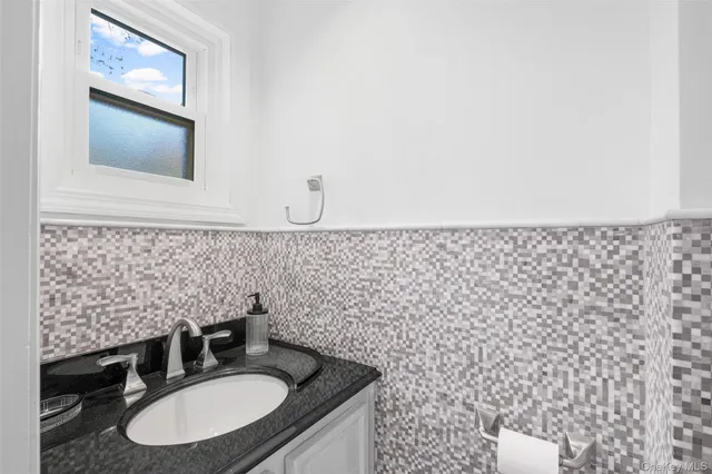 a bathroom with a sink a mirror and a toilet