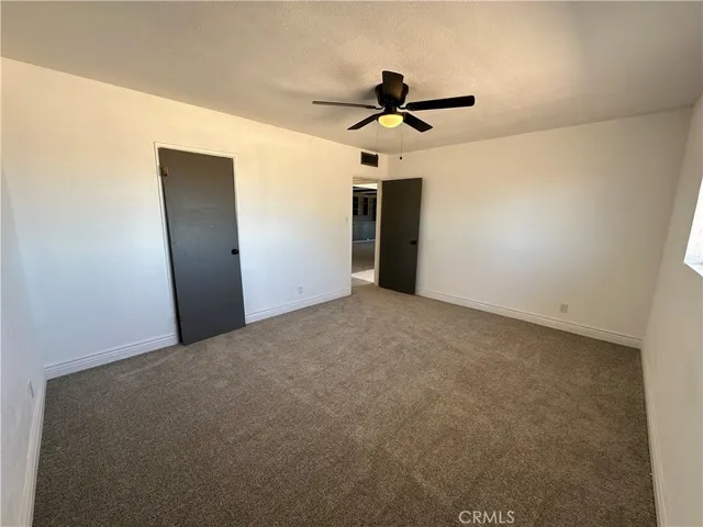 a view of a big room with a ceiling fan